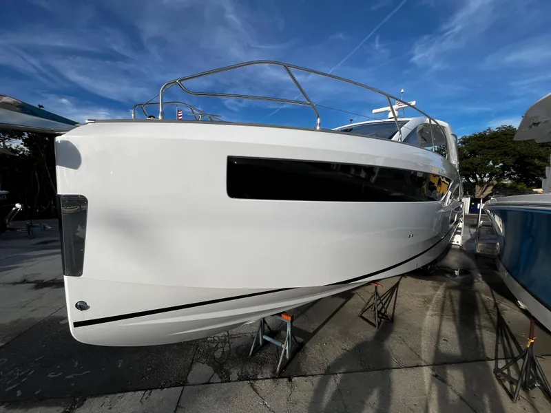 Slide: The Image of 2024 Jeanneau DB/43 OB boat on display under a clear blue sky. - 2