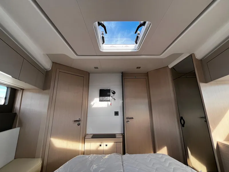 Slide: The Image of Interior cabin of 2024 Jeanneau DB/43 OB yacht with skylight and wooden finishes. - 26