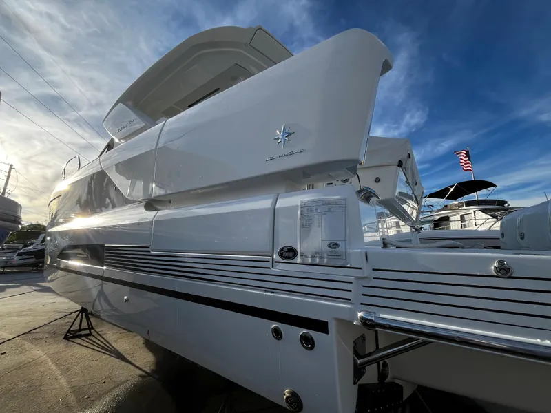 Slide: The Image of 2024 Jeanneau DB/43 OB luxury yacht, sleek design, docked under a clear sky. - 3