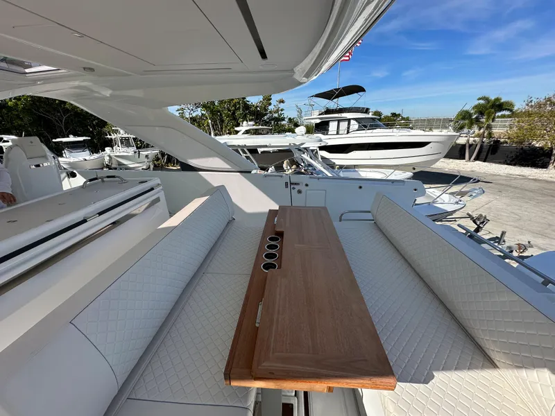 Slide: The Image of 2024 Jeanneau DB/43 OB luxury yacht with elegant seating and wooden table. - 7