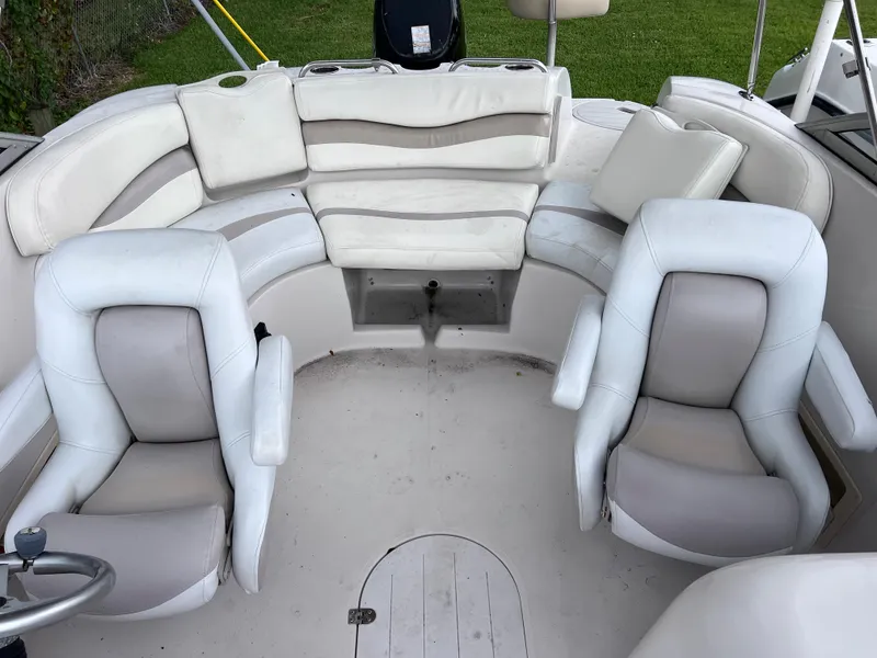 Slide: The Image of 2005 Starcraft Aurora 2210 I/O boat interior with white and beige seating. - 10