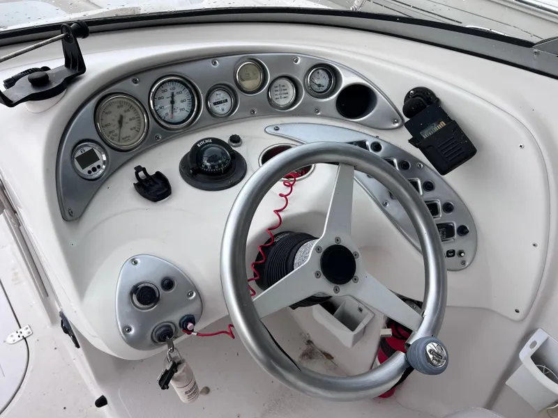 Slide: The Image of 2005 Starcraft Aurora 2210 I/O boat dashboard with steering wheel and gauges. - 12