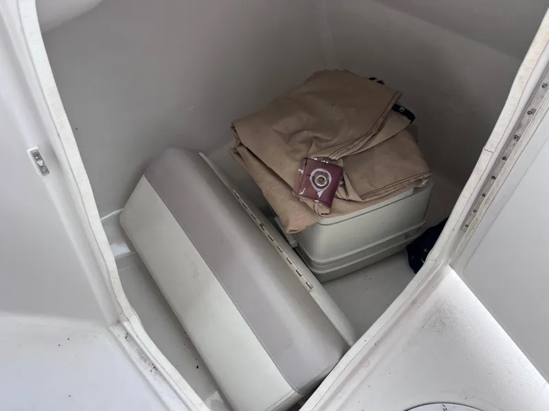 Slide: The Image of Storage compartment of a 2005 Starcraft Aurora 2210 I/O boat with folded canvas and seat cushion. - 14