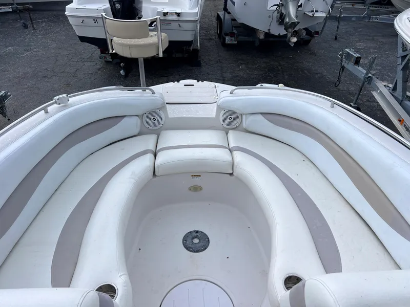 Slide: The Image of 2005 Starcraft Aurora 2210 I/O boat interior with white and beige seating. - 15