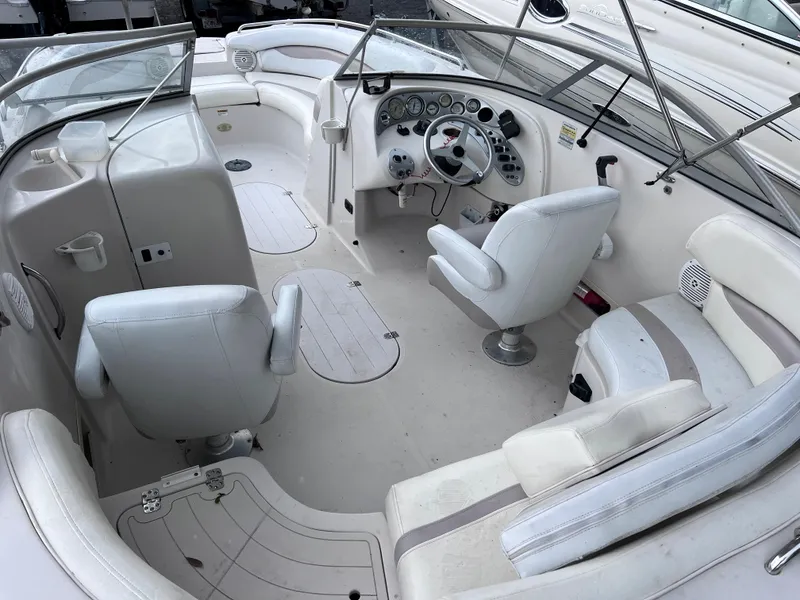 Slide: The Image of 2005 Starcraft Aurora 2210 I/O boat interior with white seating and control panel. - 8