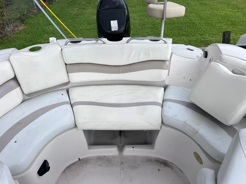 Slide: The Image of 2005 Starcraft Aurora 2210 I/O boat interior with white and gray seating. - 9