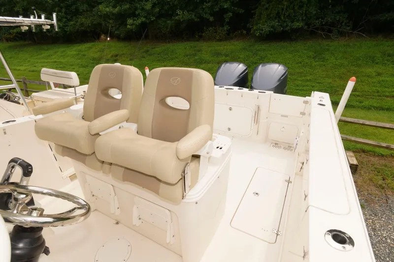 Slide: The Image of 2018 Sailfish 290 CC boat with dual seats and twin outboard motors. - 10