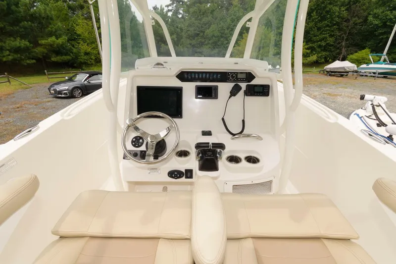 Slide: The Image of 2018 Sailfish 290 CC boat cockpit with steering wheel and control panel. - 11