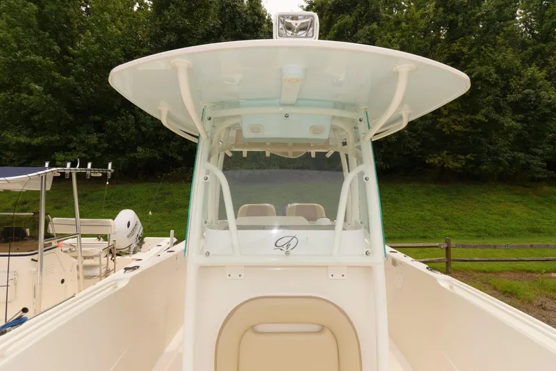 Slide: The Image of 2018 Sailfish 290 CC center console boat with T-top and windshield. - 12