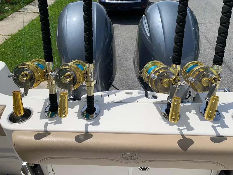 Slide: The Image of Fishing rods and reels on a 2018 Sailfish 290 CC boat with twin engines. - 20