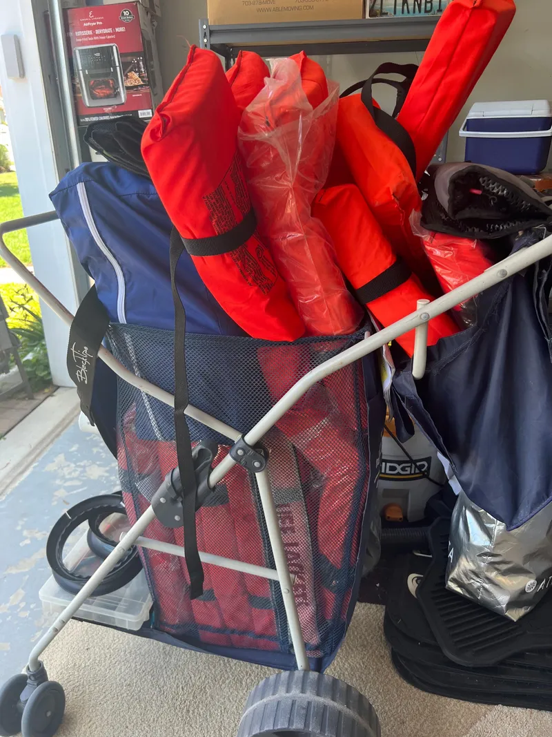 Slide: The Image of 2018 Sailfish 290 CC boat gear with life jackets in a storage cart - 24