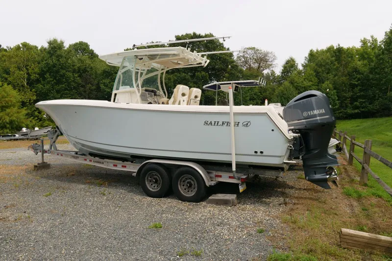 Slide: The Image of 2018 Sailfish 290 CC boat on a trailer with Yamaha outboard engines. - 3