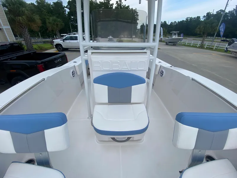 Slide: The Image of 2024 Robalo 202 EXPLORER boat interior with blue and white seating. - 16