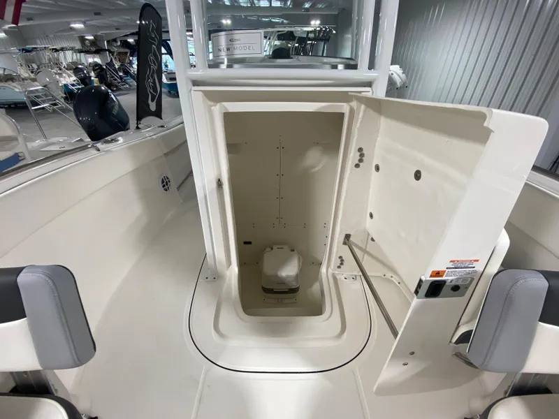 Slide: The Image of 2024 Robalo R230 Center Console boat interior with open storage compartment. - 15