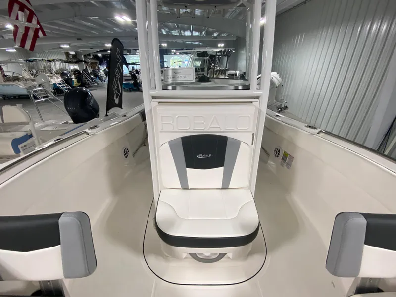 Slide: The Image of 2024 Robalo R230 Center Console boat interior at a showroom. - 16
