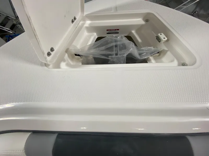 Slide: The Image of 2024 Robalo R230 Center Console storage compartment with open hatch. - 20