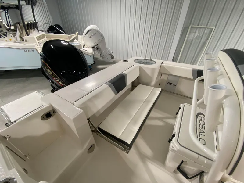 Slide: The Image of 2024 Robalo R230 Center Console boat interior with seating and rod holders. - 5