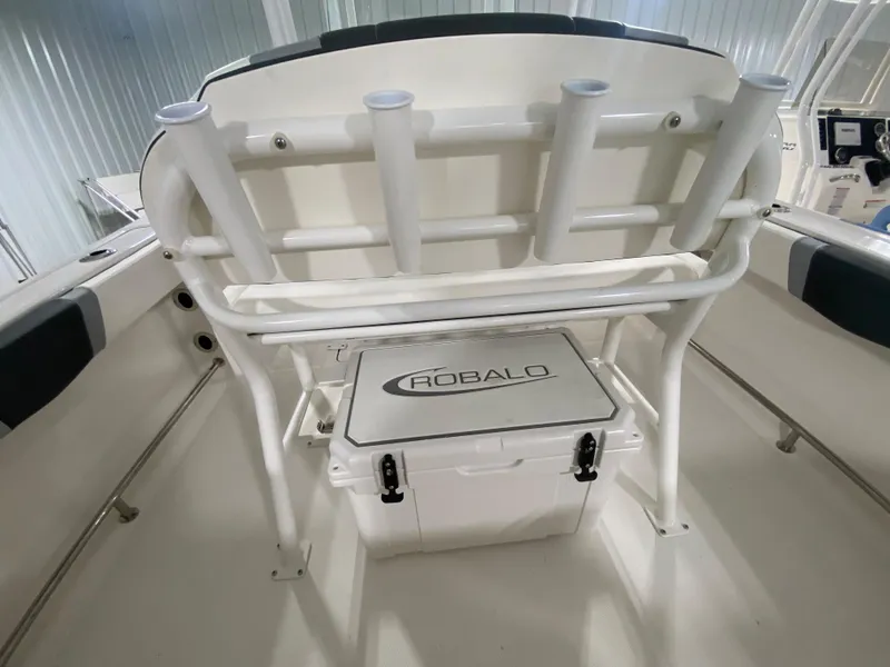 Slide: The Image of 2024 Robalo R230 Center Console boat interior with rod holders and cooler. - 7