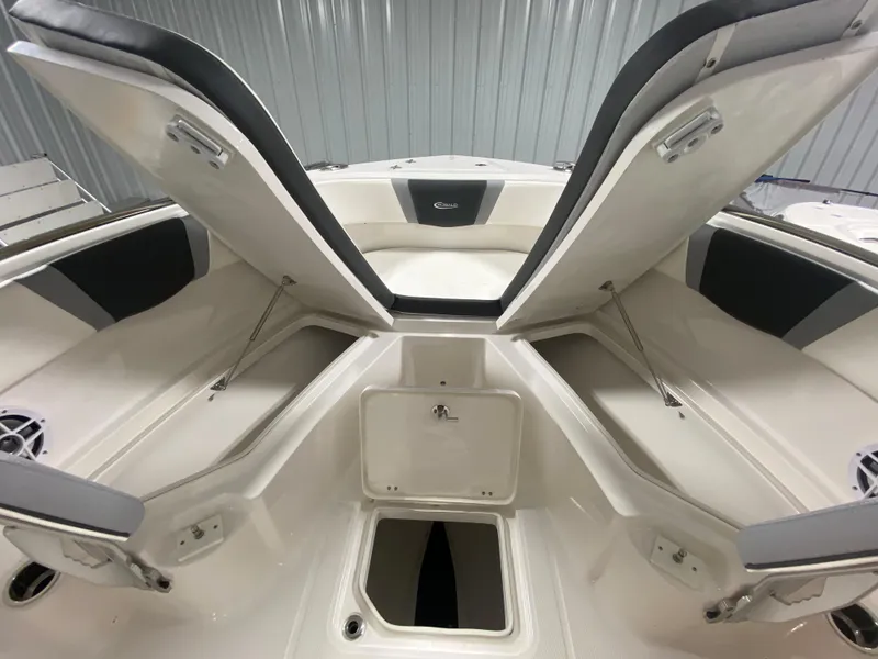 Slide: The Image of 2024 Robalo R230 Center Console boat with open storage compartments. - 19