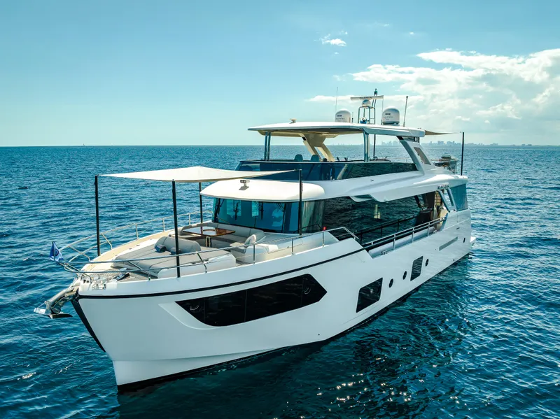 Slide: The Image of Luxurious 2022 Absolute Navetta 73 yacht cruising on open sea under clear skies. - 1