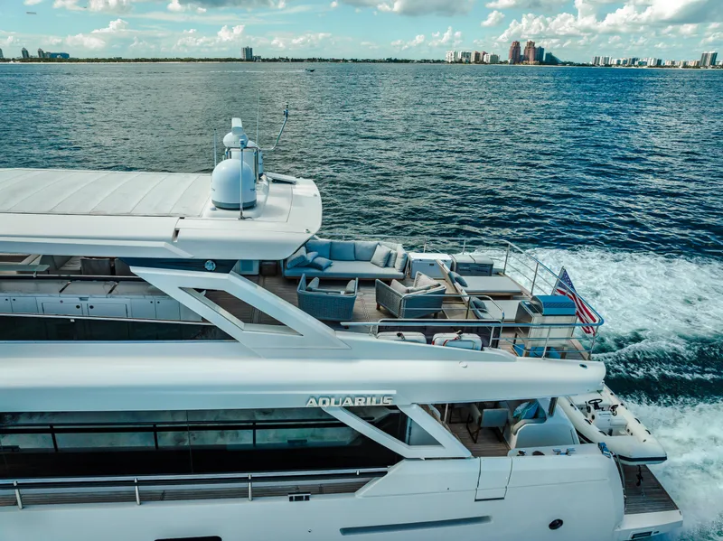 Slide: The Image of Luxury Absolute Navetta 73 yacht cruising on open water, 2022 model, with spacious deck seating. - 10