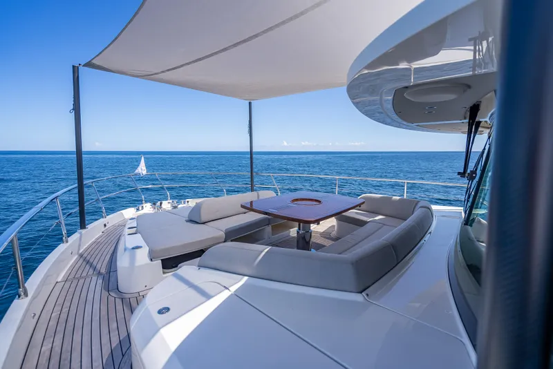 Slide: The Image of Luxurious 2022 Absolute Navetta 73 yacht deck with seating, ocean view, and canopy. - 12