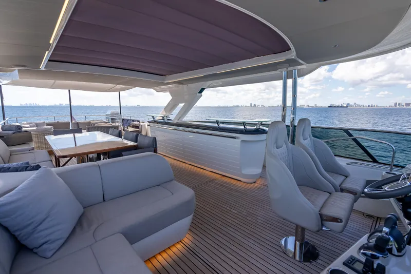 Slide: The Image of Luxurious 2022 Absolute Navetta 73 yacht interior with seating, table, and ocean view. - 16