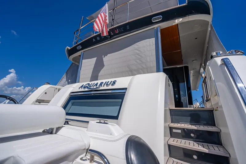 Slide: The Image of Luxury yacht Absolute Navetta 73, 2022 model, with American flag and "Aquarius" nameplate. - 20
