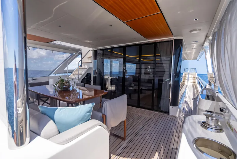Slide: The Image of Luxurious 2022 Absolute Navetta 73 yacht interior with elegant dining area and ocean view. - 21