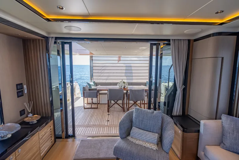 Slide: The Image of Luxurious interior of 2022 Absolute Navetta 73 yacht with ocean view and elegant seating area. - 23