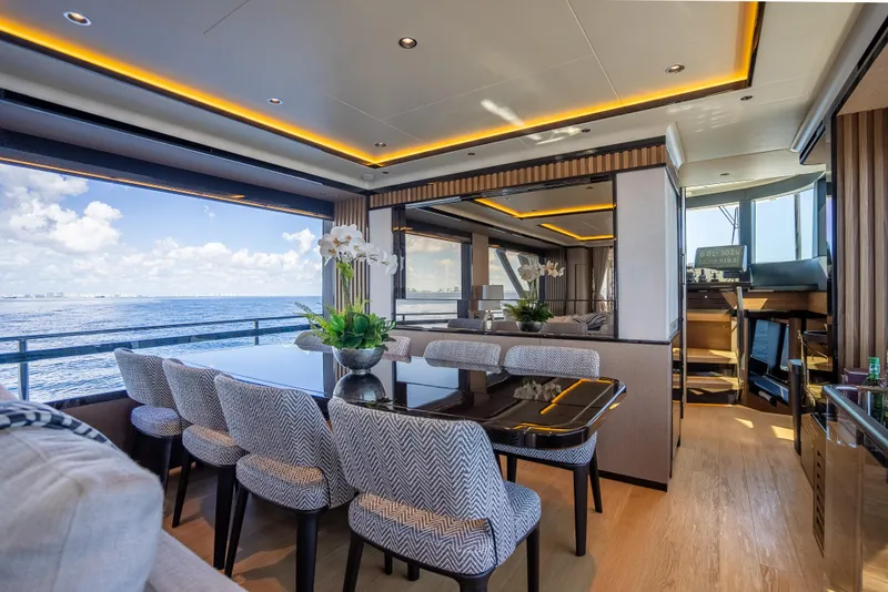 Slide: The Image of Luxurious interior of 2022 Absolute Navetta 73 yacht with ocean view and elegant dining area. - 27