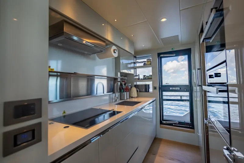 Slide: The Image of Modern kitchen interior on 2022 Absolute Navetta 73 yacht, featuring sleek design and ocean view. - 29