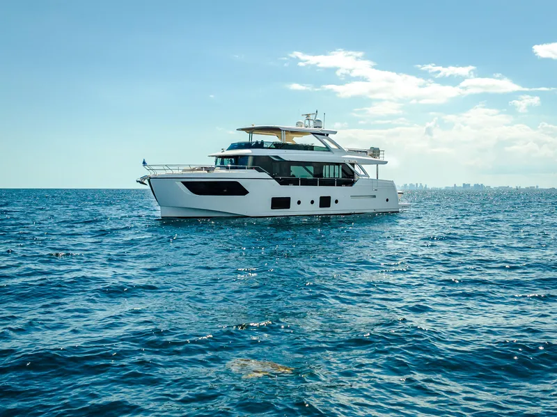 Slide: The Image of 2022 Absolute Navetta 73 yacht cruising on open sea under clear sky. - 3