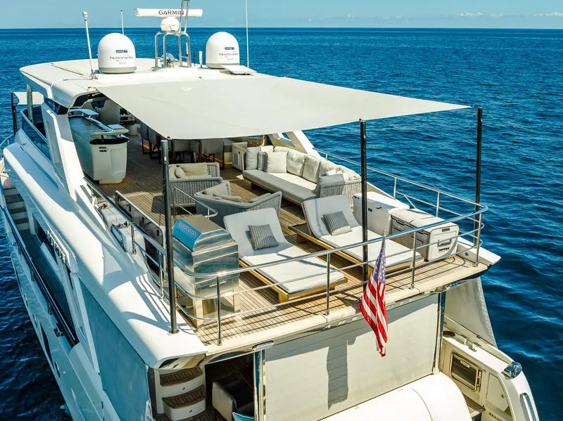 Slide: The Image of Luxurious 2022 Absolute Navetta 73 yacht with spacious deck and elegant seating on open sea. - 5