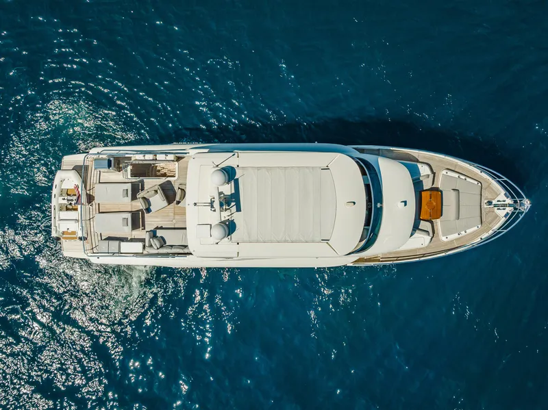 Slide: The Image of Aerial view of 2022 Absolute Navetta 73 yacht cruising on blue ocean waters. - 8