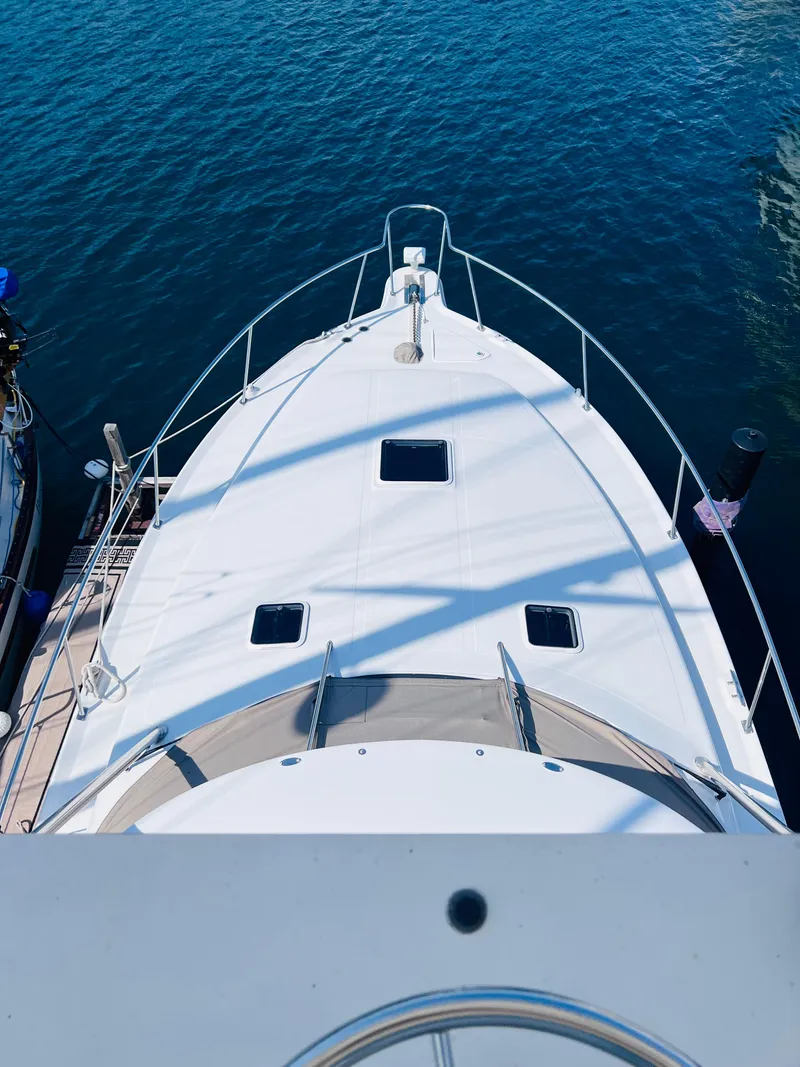 Slide: The Image of Top view of a 1998 Sea Ray Express Cruiser docked on calm water. - 12
