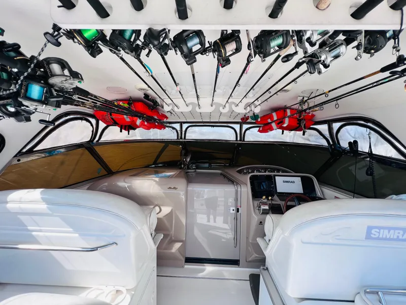 Slide: The Image of 1998 Sea Ray Express Cruiser interior with fishing rods and navigation equipment. - 16