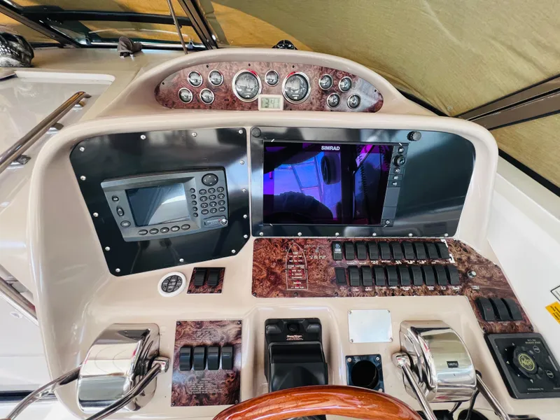 Slide: The Image of 1998 Sea Ray Express Cruiser dashboard with navigation controls and instruments. - 17