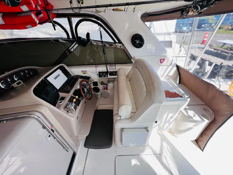Slide: The Image of 1998 Sea Ray Express Cruiser cockpit with steering wheel, navigation system, and seating. - 18