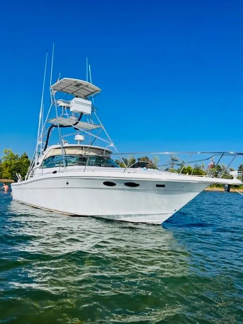 Slide: The Image of 1998 Sea Ray Express Cruiser on water under clear blue sky. - 2