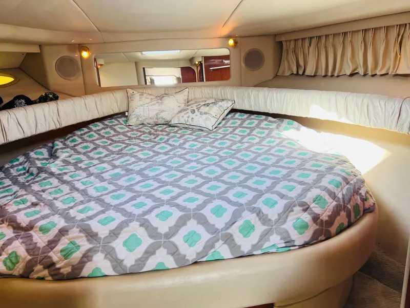 Slide: The Image of Cozy cabin interior of 1998 Sea Ray Express Cruiser with patterned bedding. - 26