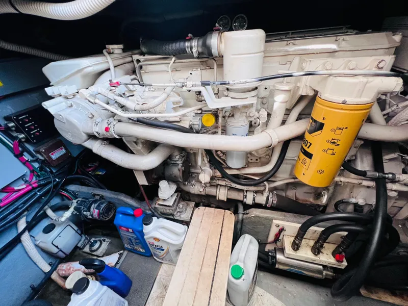 Slide: The Image of Engine room of a 1998 Sea Ray Express Cruiser with visible components and maintenance supplies. - 28