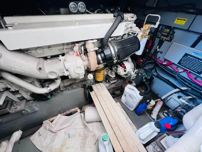 Slide: The Image of Engine compartment of a 1998 Sea Ray Express Cruiser with various maintenance supplies. - 29