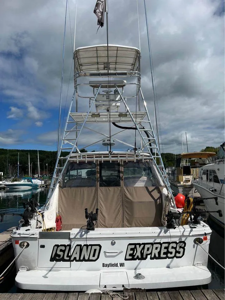 Slide: The Image of 1998 Sea Ray Express Cruiser docked, named "Island Express," in Bayfield, WI marina. - 8