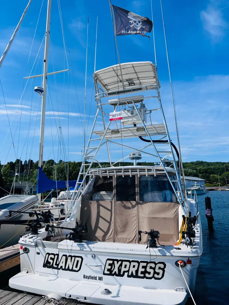 Slide: The Image of 1998 Sea Ray Express Cruiser docked, named "Island Express," with a pirate flag. - 9