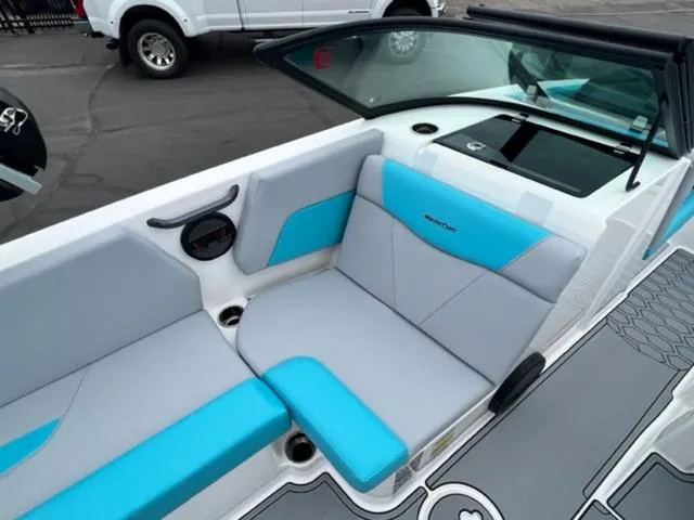 Slide: The Image of 2023 MasterCraft NXT22 boat interior with blue and gray seating. - 12