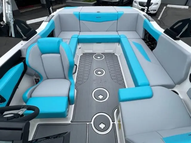 Slide: The Image of 2023 MasterCraft NXT22 boat interior with blue and gray seating and modern design. - 17
