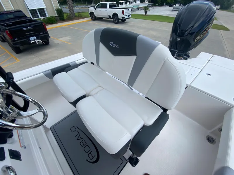 Slide: The Image of 2024 Robalo 246 Cayman boat interior with white and gray seating. - 13