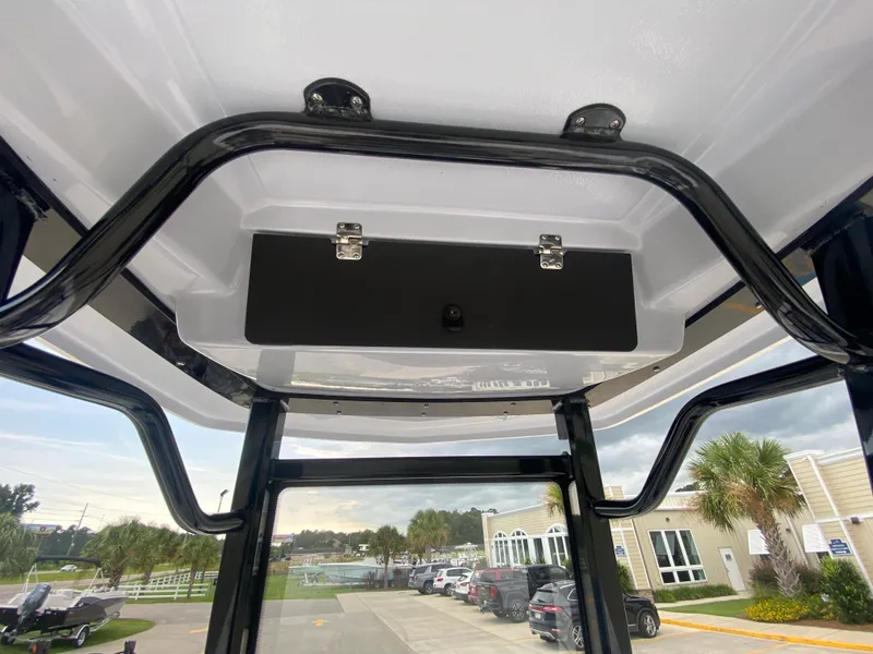 Slide: The Image of 2024 Robalo 246 Cayman T-top storage compartment. - 15