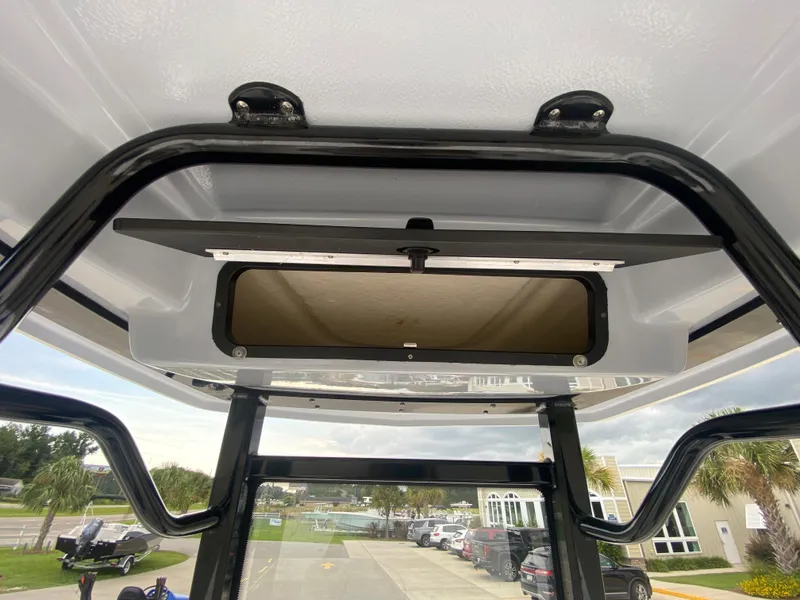 Slide: The Image of 2024 Robalo 246 Cayman boat T-top with storage compartment. - 16